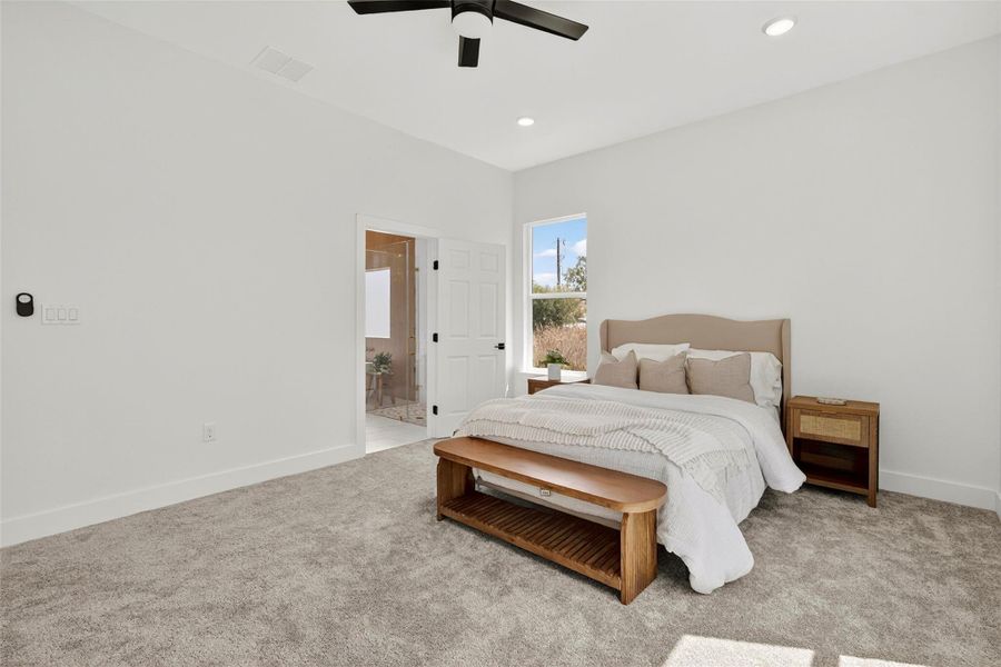 Bedroom with carpet flooring, ceiling fan, connected bathroom, and recessed lighting