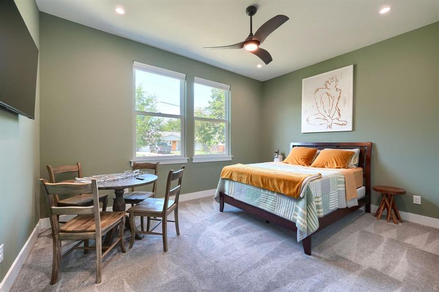 Bedroom with light carpet, a ceiling fan, and recessed lighting Bedroom with light carpet, a ceiling fan, and recessed lighting