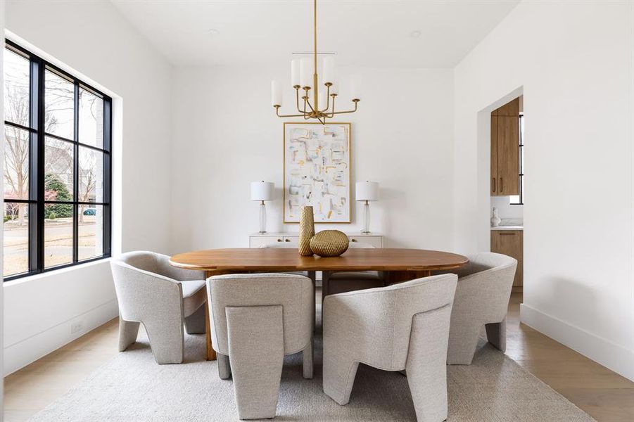 Dining space featuring a chandelier, light wood-style flooring, and baseboards