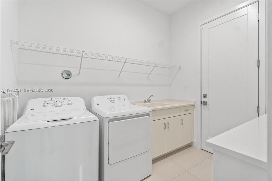 Huge laundry room with entry door from garage