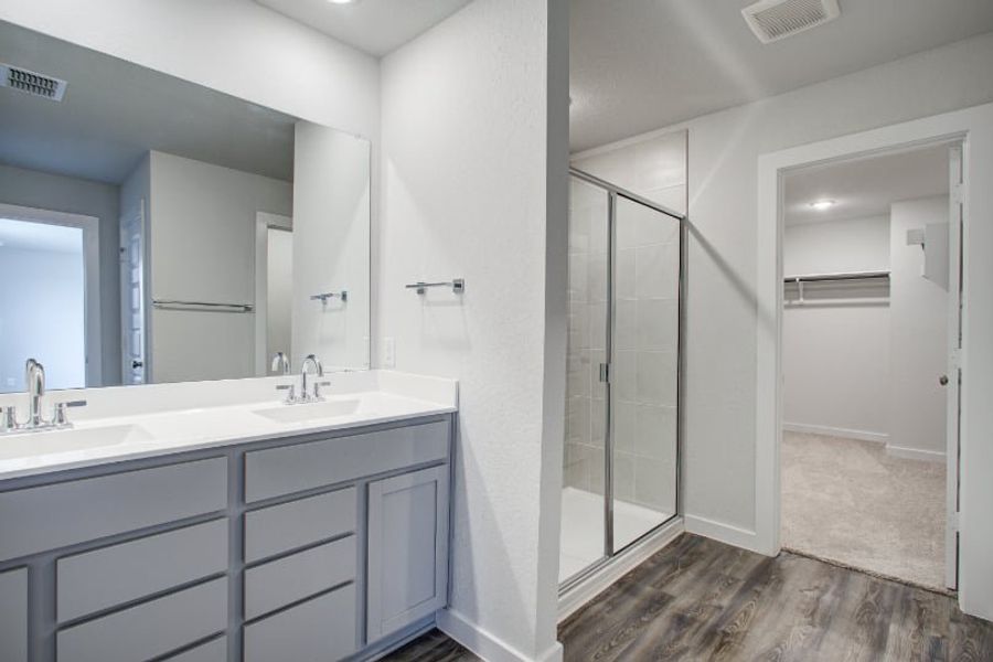 A bathroom with a glass shower. A bathroom with a glass shower.