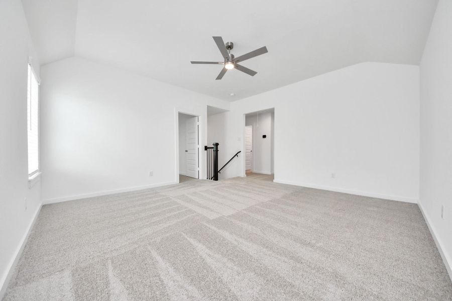 Ascend to relaxation in this fantastic game room! Ideal for both casual gatherings and adult gaming, it boasts plush carpet, lofty ceilings, custom paint, and ample windows for abundant natural light. Sample photo of completed home with similar floor plan. Actual colors and selections may vary.