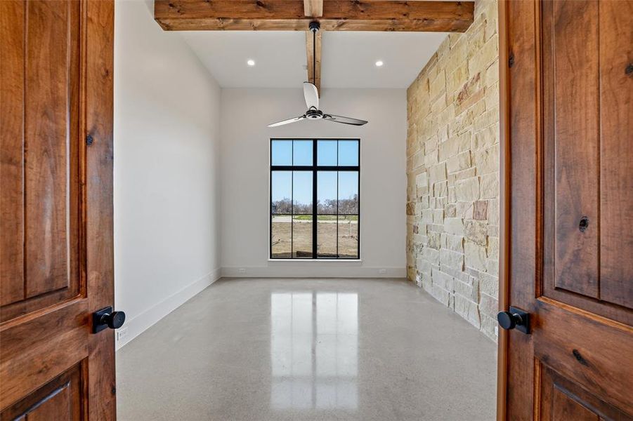 Office featuring beamed ceiling and stone accent wall Office featuring beamed ceiling and stone accent wall
