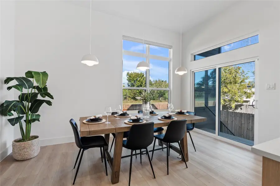 The dining area is positioned as a natural extension of the kitchen, with clear visual alignment and spacing that supports effortless transition between preparation and gathering.