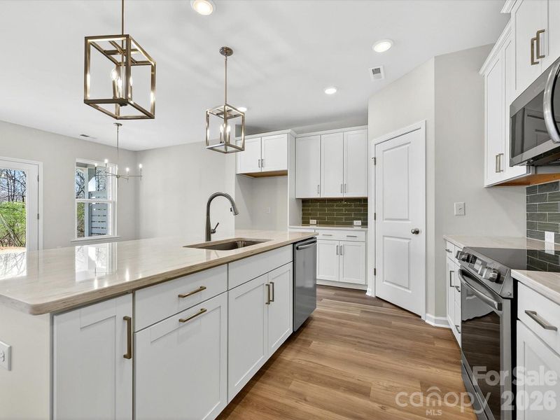 42" cabinets with soft close doors & drawers, Quartz countertops, tile backsplash, Frigidaire gallery appliances. Shiplap accent Island. Cooking exhaust vented to the outside