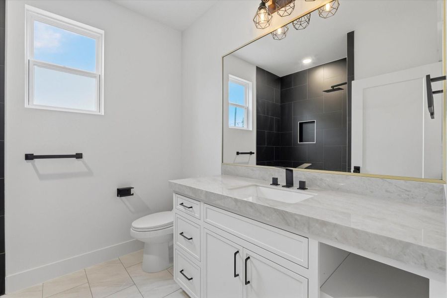 Full bathroom upstairs complete with plenty of storage and counterspace.