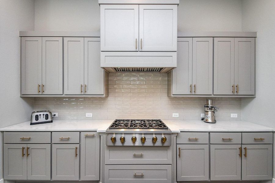 Professional-grade Monogram 6-burner gas cooktop and pull out spice rack. Professional-grade Monogram 6-burner gas cooktop and pull out spice rack.