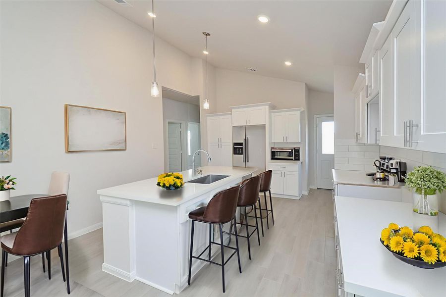 The space is a culinary dream, featuring sleek white cabinetry and pristine countertops that provide a clean and contemporary aesthetic. The space is a culinary dream, featuring sleek white cabinetry and pristine countertops that provide a clean and contemporary aesthetic.