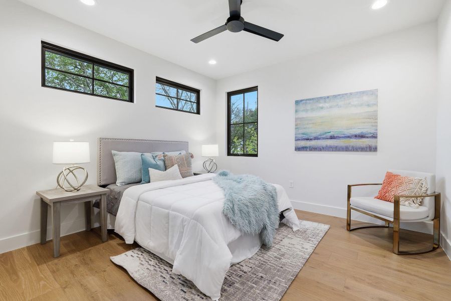 Bedroom featuring light wood-style flooring, ceiling fan, and recessed lighting