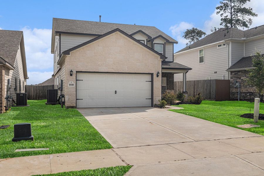 Front exterior of a new home in Grand Oaks Reserve, Cleveland, TX, highlighting curb appeal (Image 25).