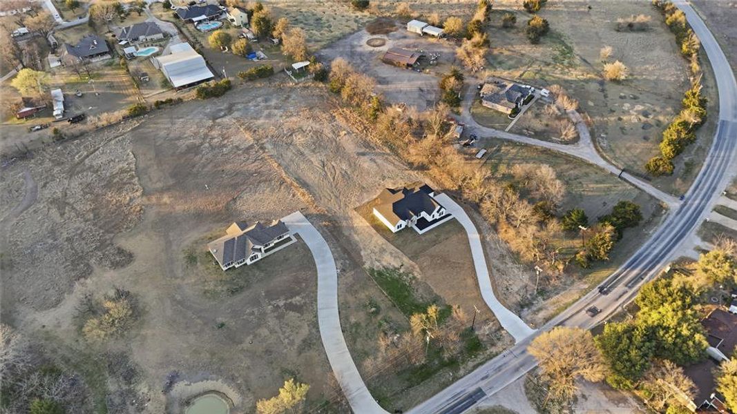 Aerial view of property's location with nearby suburban area