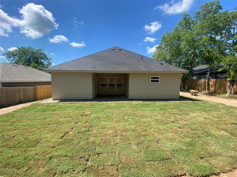 Rear view of house featuring a yard