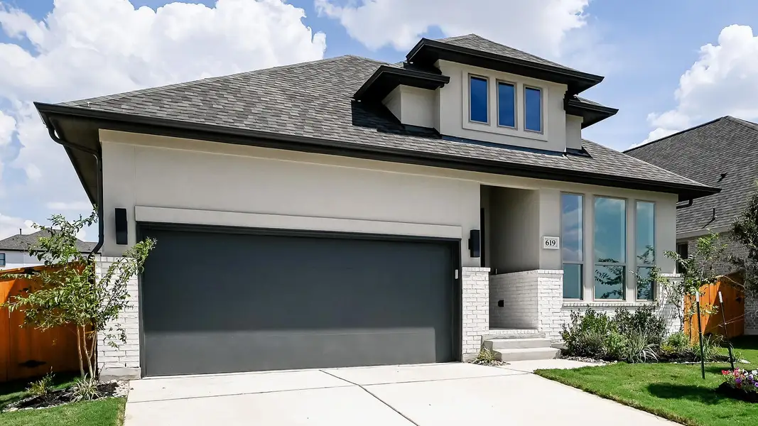 View of front of house featuring brick siding, driveway, roof with shingles, and an attached garage View of front of house featuring brick siding, driveway, roof with shingles, and an attached garage