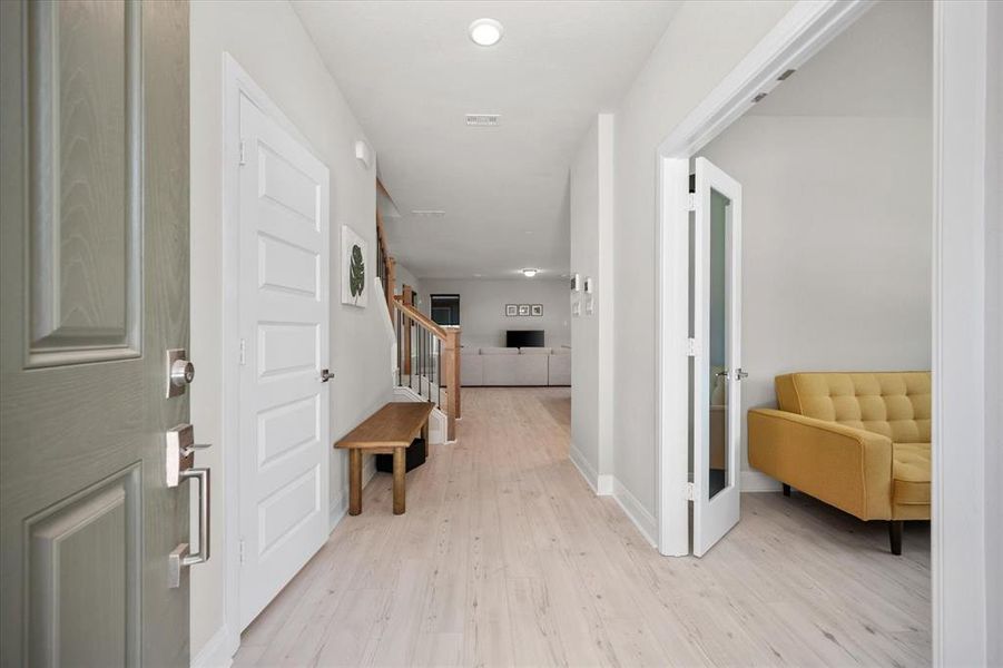Entry featuring light wood finished floors, stairway, and recessed lighting Entry featuring light wood finished floors, stairway, and recessed lighting