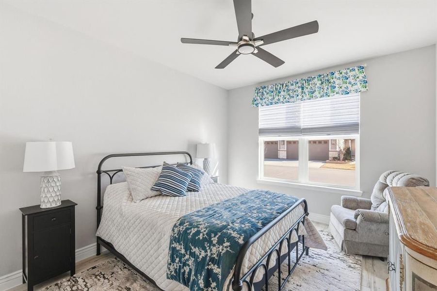 Bedroom featuring a ceiling fan and light wood-type flooring