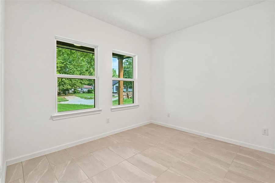 Unfurnished room featuring baseboards and light tile patterned floors