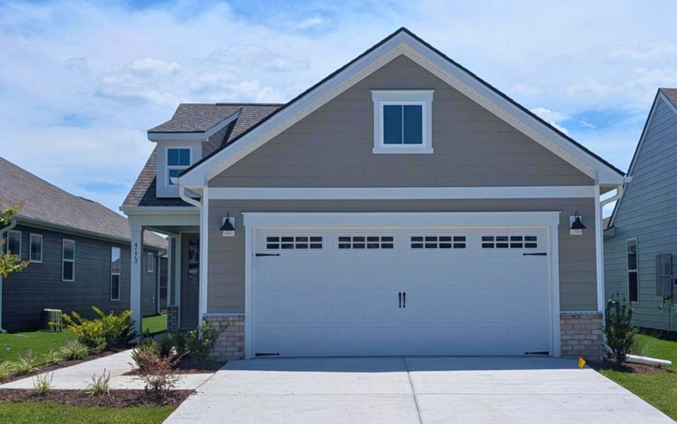 Front exterior of a new home in Del Webb Wilmington at Mallory Creek, Leland, NC, highlighting curb appeal (Image 4). Front exterior of a new home in Del Webb Wilmington at Mallory Creek, Leland, NC, highlighting curb appeal (Image 4).