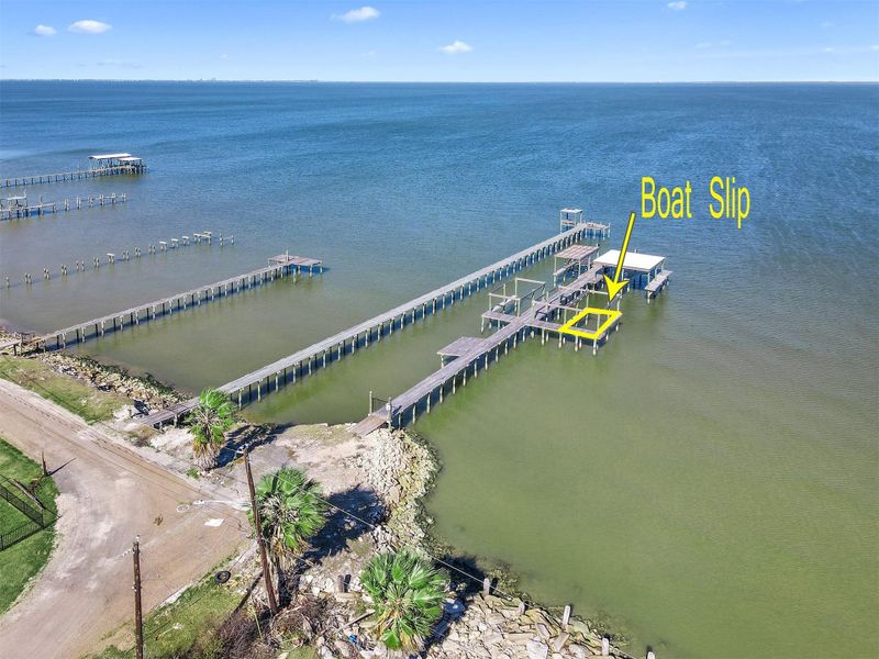 The property conveys shared ownership of a private waterfront pier with use of a designated boat slip