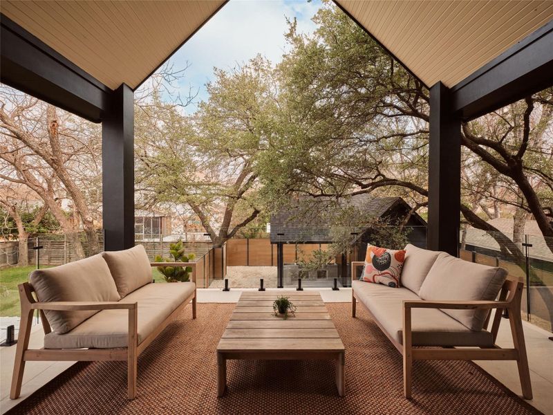 Fenced backyard with an outdoor hangout area and a patio area