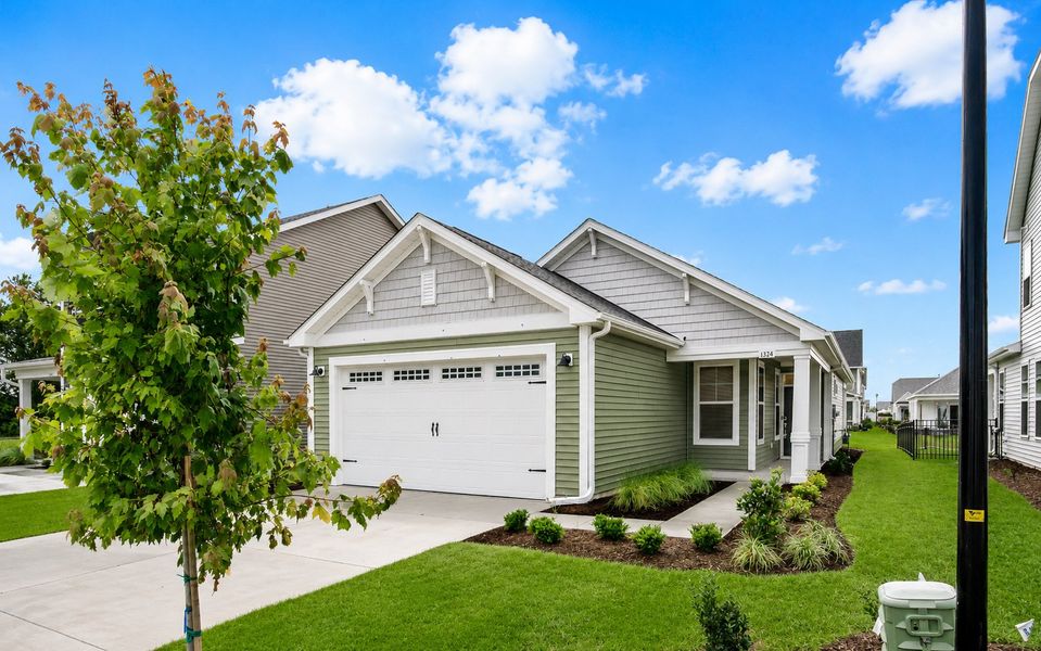 Front exterior of a new home in Traditions at Carolina Forest, Myrtle Beach, SC, highlighting curb appeal (Image 1). Front exterior of a new home in Traditions at Carolina Forest, Myrtle Beach, SC, highlighting curb appeal (Image 1).