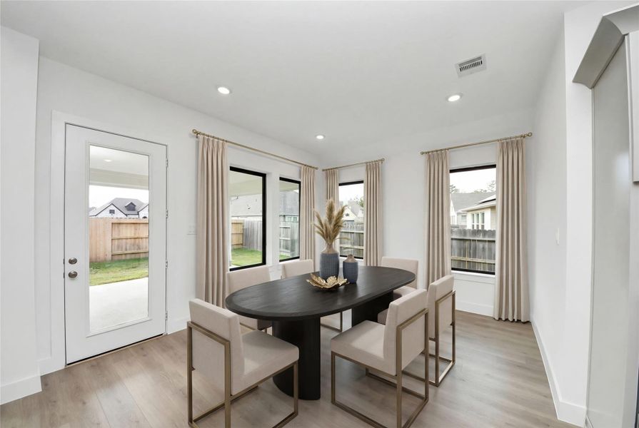 The breakfast room is filled with natural light and features high ceilings, recessed lighting, and expansive windows. The breakfast room is filled with natural light and features high ceilings, recessed lighting, and expansive windows.