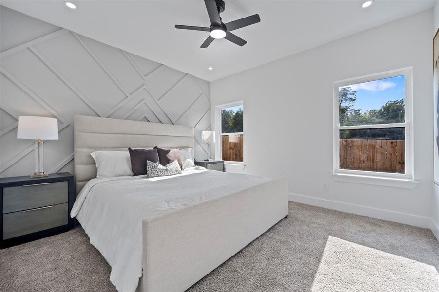 Bedroom featuring light carpet and ceiling fan