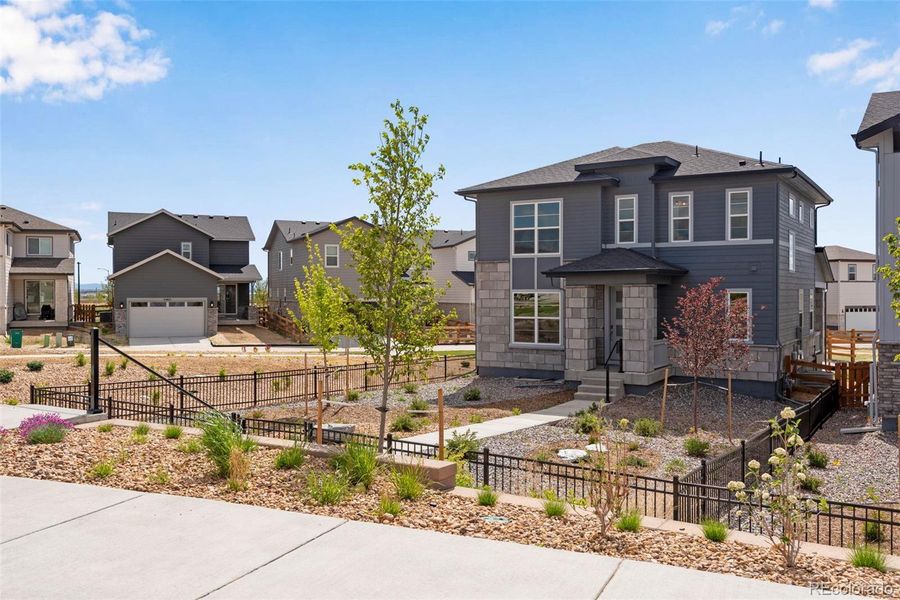 Front exterior of a new home in Crescendo at The Aurora Highlands, Aurora, CO, highlighting curb appeal (Image 2).