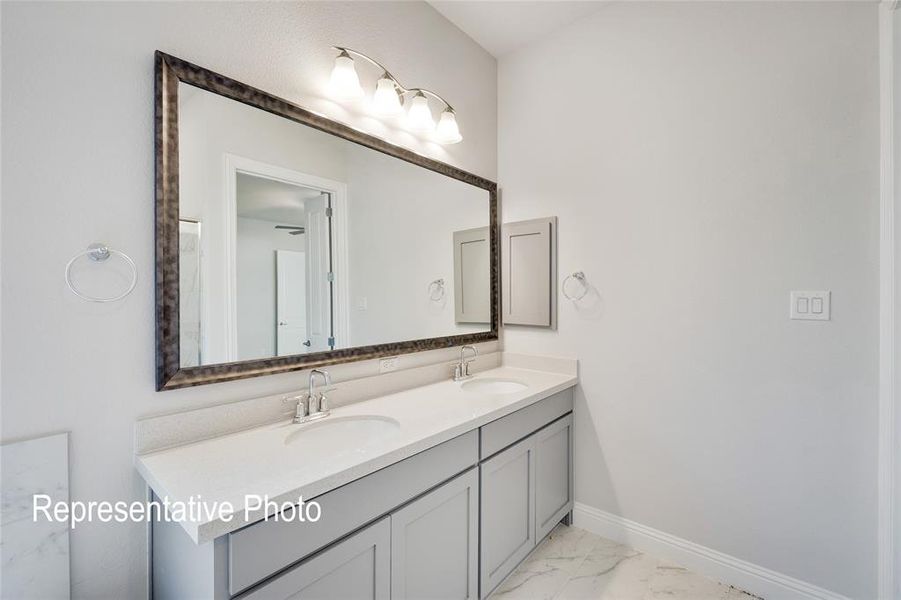 Bathroom with double sink, tile floors, and large vanity