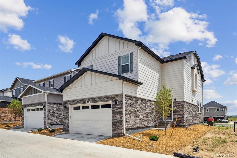 Front exterior of a new home in Horizon Uptown, Aurora, CO, highlighting curb appeal (Image 2).