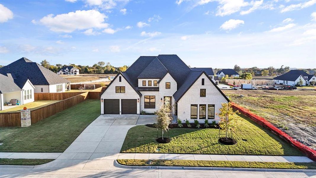 View of front of home with concrete driveway, a residential view, and brick siding View of front of home with concrete driveway, a residential view, and brick siding