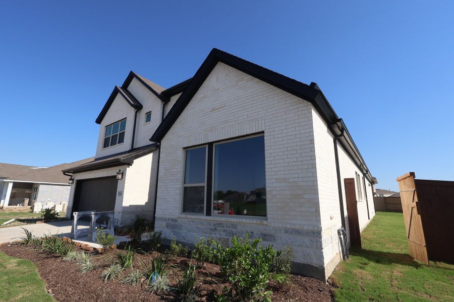 Front exterior of a new home in Meridiana - Ascent Collection, Manvel, TX, highlighting curb appeal (Image 2).