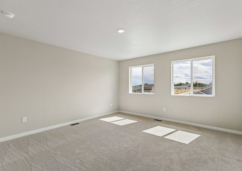 The master bedroom is spacious with large windows.