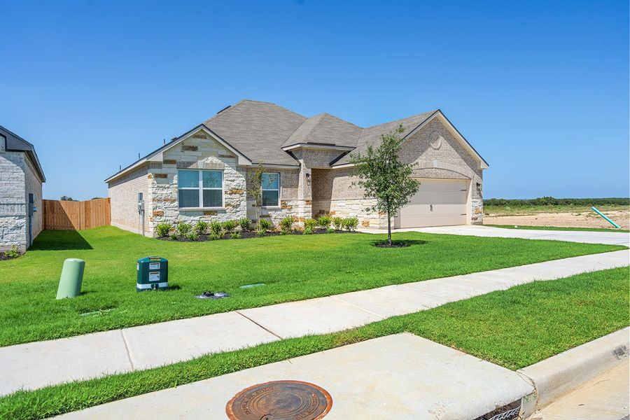 Front exterior of a new home in Colson Ranch, Jarrell, TX, highlighting curb appeal (Image 1). Front exterior of a new home in Colson Ranch, Jarrell, TX, highlighting curb appeal (Image 1).