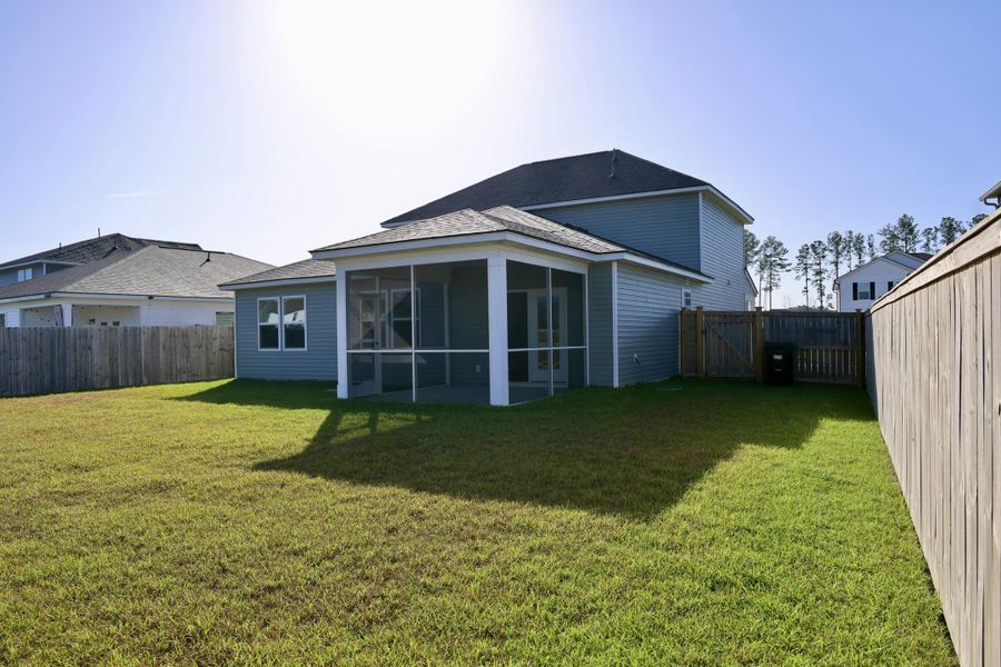 Exterior details and patio area of a home in Sanctuary Cove at Cane Bay, Summerville (Image 3).
