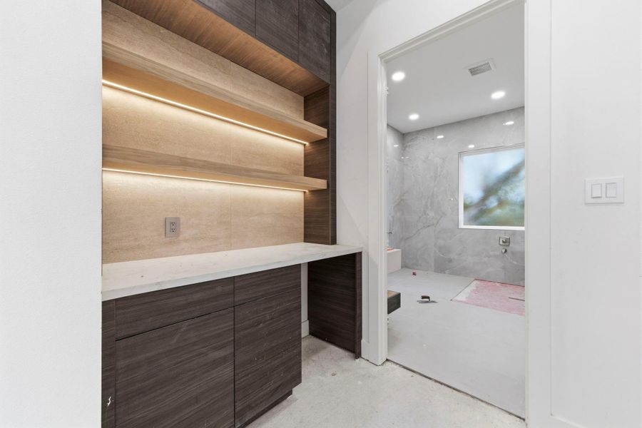 Custom built-in at the end of the hallway on the second floor, situated between the primary bedroom and bathroom. Ideal for a coffee station, including a small refrigerator.. Custom built-in at the end of the hallway on the second floor, situated between the primary bedroom and bathroom. Ideal for a coffee station, including a small refrigerator..