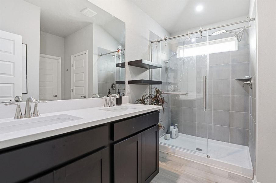 The oversized walk-in shower is equipped with dual shower heads.