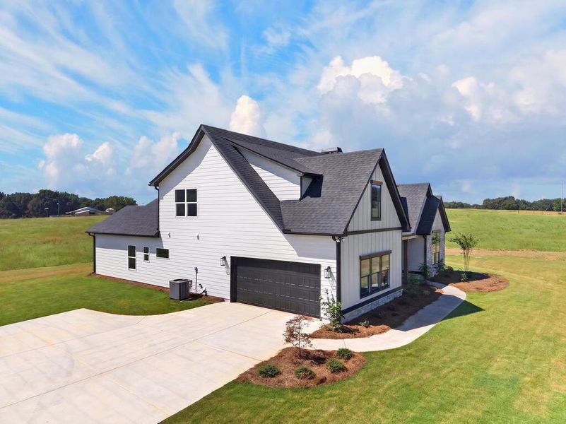 Front exterior of a new home in Veal Meadows, Roopville, GA, highlighting curb appeal (Image 28). Front exterior of a new home in Veal Meadows, Roopville, GA, highlighting curb appeal (Image 28).