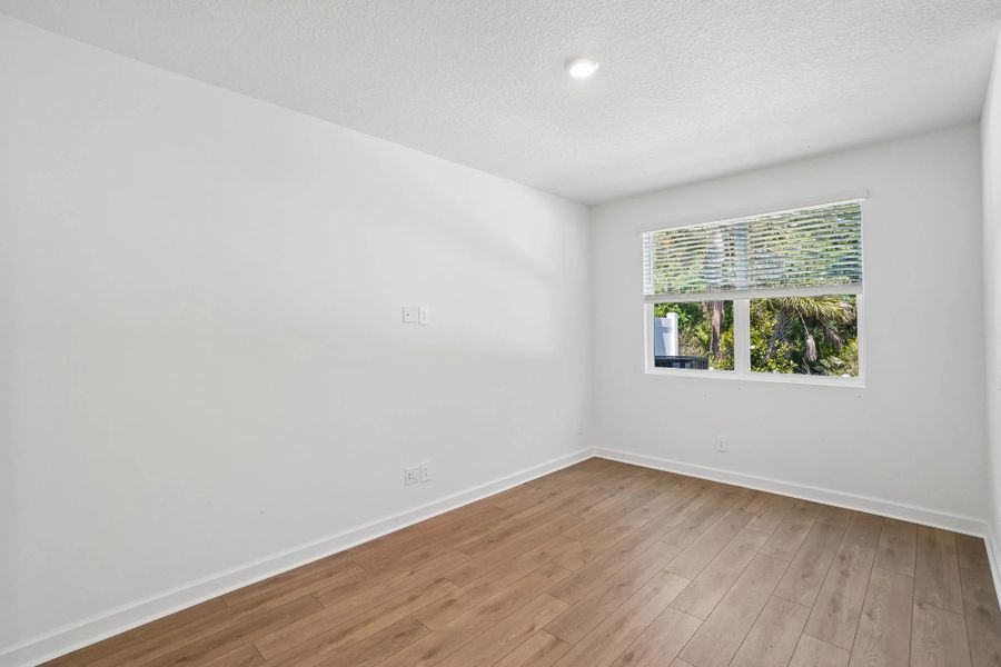 Family room featuring a double window and beautiful tree backdrop Family room featuring a double window and beautiful tree backdrop