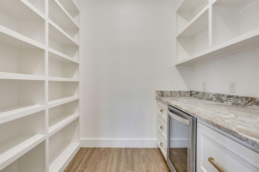 walk in pantry with butlers area with wine fridge