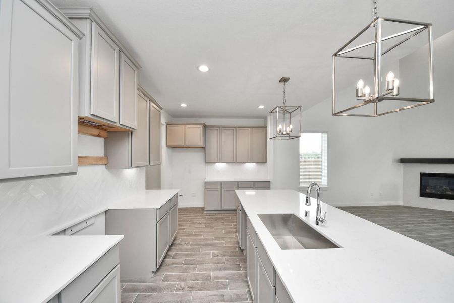The kitchen is a culinary haven, featuring granite countertops, a tile backsplash, stainless steel appliances, 42” upper cabinets, and undercabinet lighting. The kitchen is a culinary haven, featuring granite countertops, a tile backsplash, stainless steel appliances, 42” upper cabinets, and undercabinet lighting.