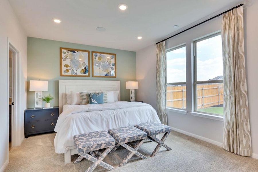A bedroom with a bed and a bench. A bedroom with a bed and a bench.