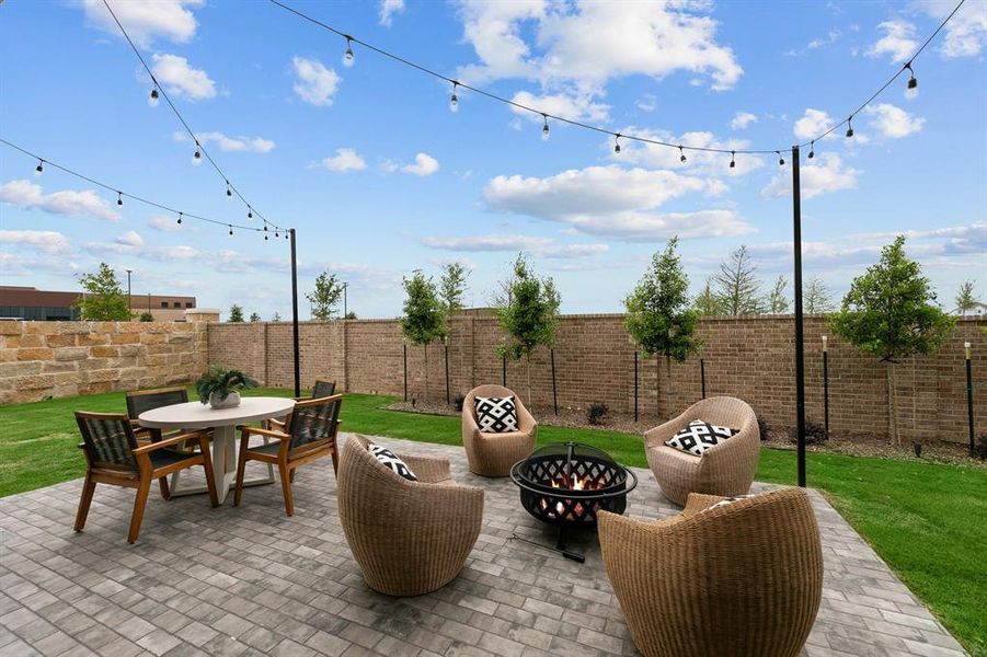 Fenced backyard featuring outdoor dining space, a patio, and a fire pit Fenced backyard featuring outdoor dining space, a patio, and a fire pit