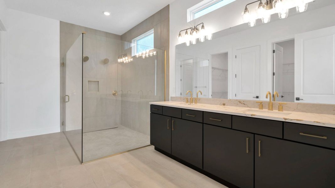 The Primary Bathroom of a DRB Homes Grand Hawk which is offered as a home plan at Serengeti in Spring Hill, FL.