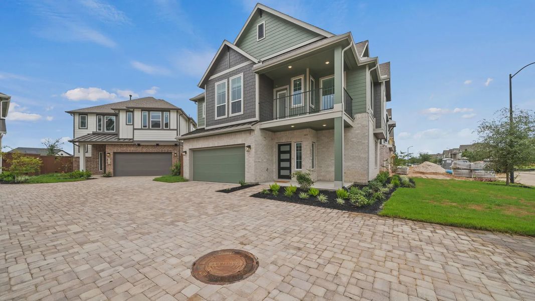 Front exterior of a new home in Elyson Courtyard Collection, Katy, TX, highlighting curb appeal (Image 18). Front exterior of a new home in Elyson Courtyard Collection, Katy, TX, highlighting curb appeal (Image 18).