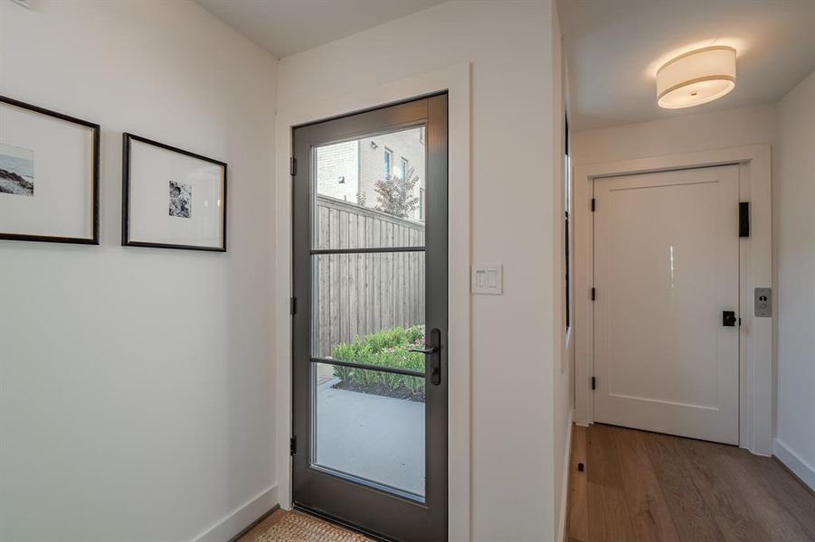 Doorway featuring wood finished floors and baseboards Doorway featuring wood finished floors and baseboards