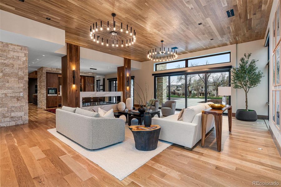 Living Room with beautiful wide plank white oak floors, white oak ceilings, Jerusalem limestone accents walls, Luton ceilings and floor up-lighting as well as Luton mechanical shades.