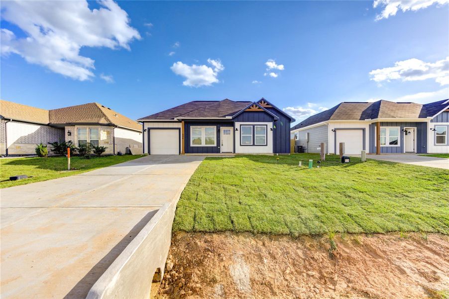 Front exterior of a new home in , Cleveland, TX, highlighting curb appeal (Image 1).