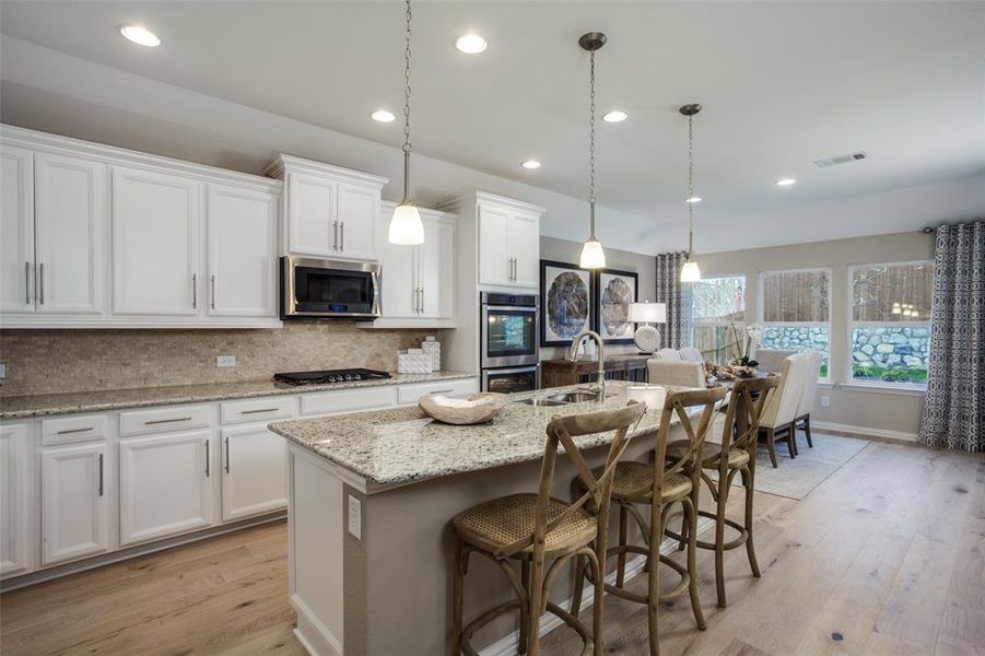 Bright kitchen with an expansive center island perfect for gatherings *Model representation Bright kitchen with an expansive center island perfect for gatherings *Model representation