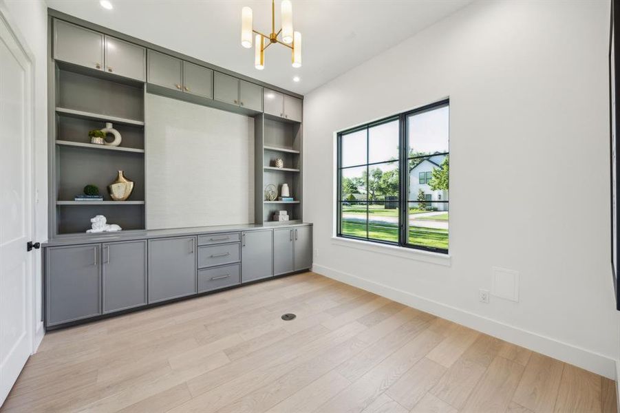 Downstairs private study with built ins, wallpaper and custom lighting. Downstairs private study with built ins, wallpaper and custom lighting.