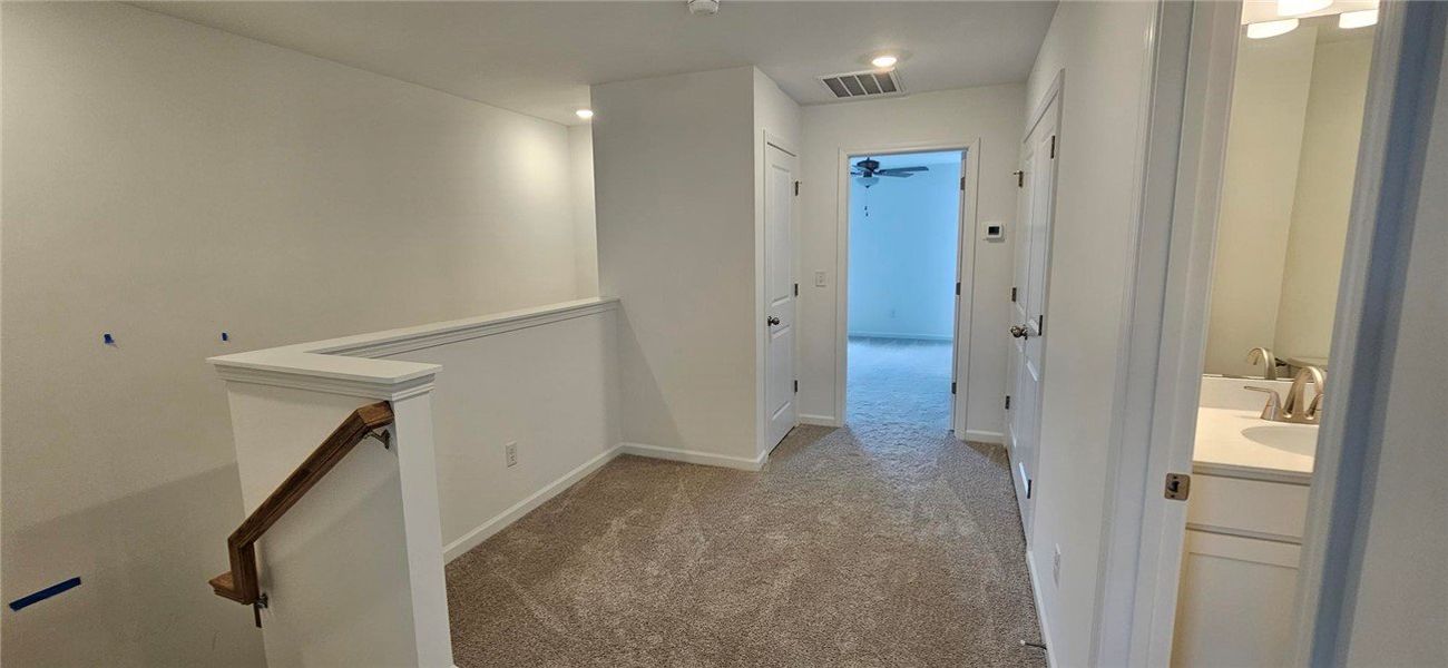 This spacious hallway features carpet flooring, le This spacious hallway features carpet flooring, le